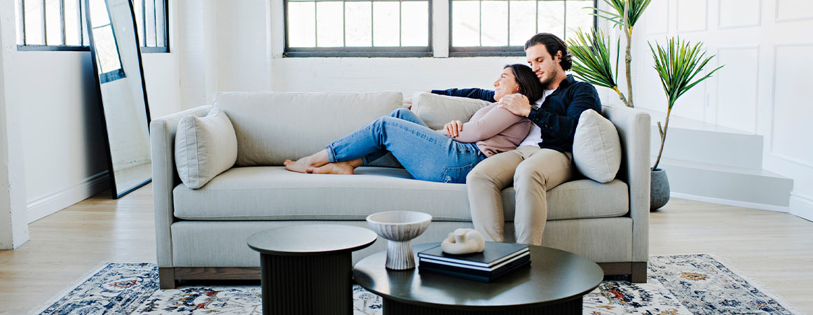 a couple lounging on a custom sofa made in toronto